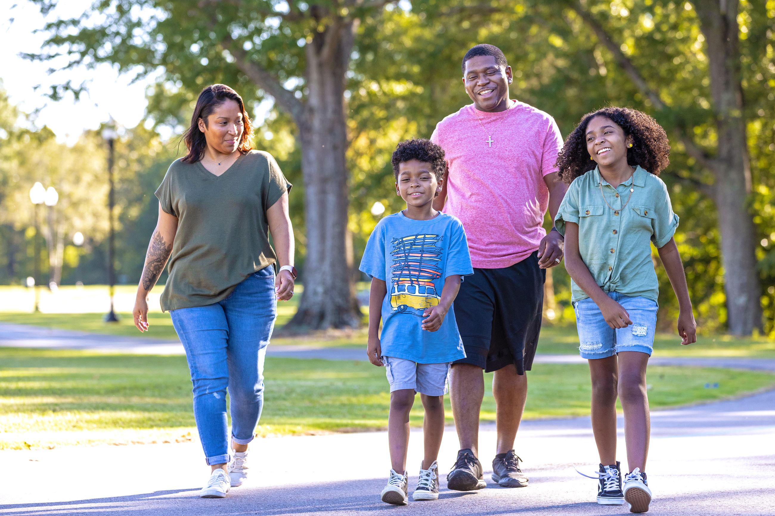 Mom, dad and two children walking in the park